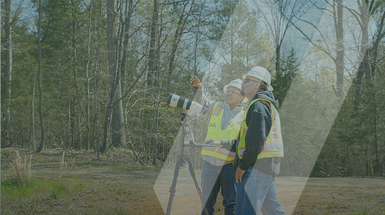 two SAM field crew members using the latest technology to measure and record data