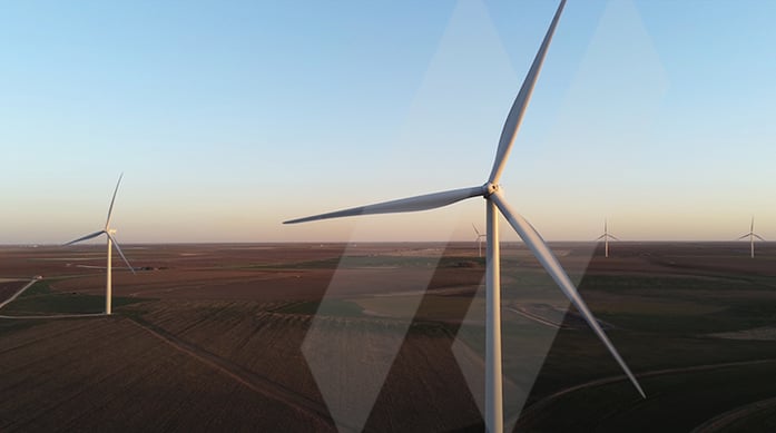 Wind turbines in an open field with SAM innovation bars layered over